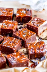 Salted Caramel Chocolate Fudge squares on brown parchment paper