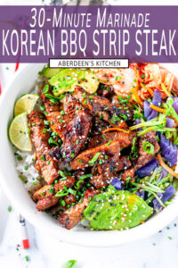 Korean BBQ Strip Steak in white bowl with rice, avocado, cabbage mix, kimchi and limes topped with green onion, chives, and sesame seeds on white marble - purple rectangle overlay with white text